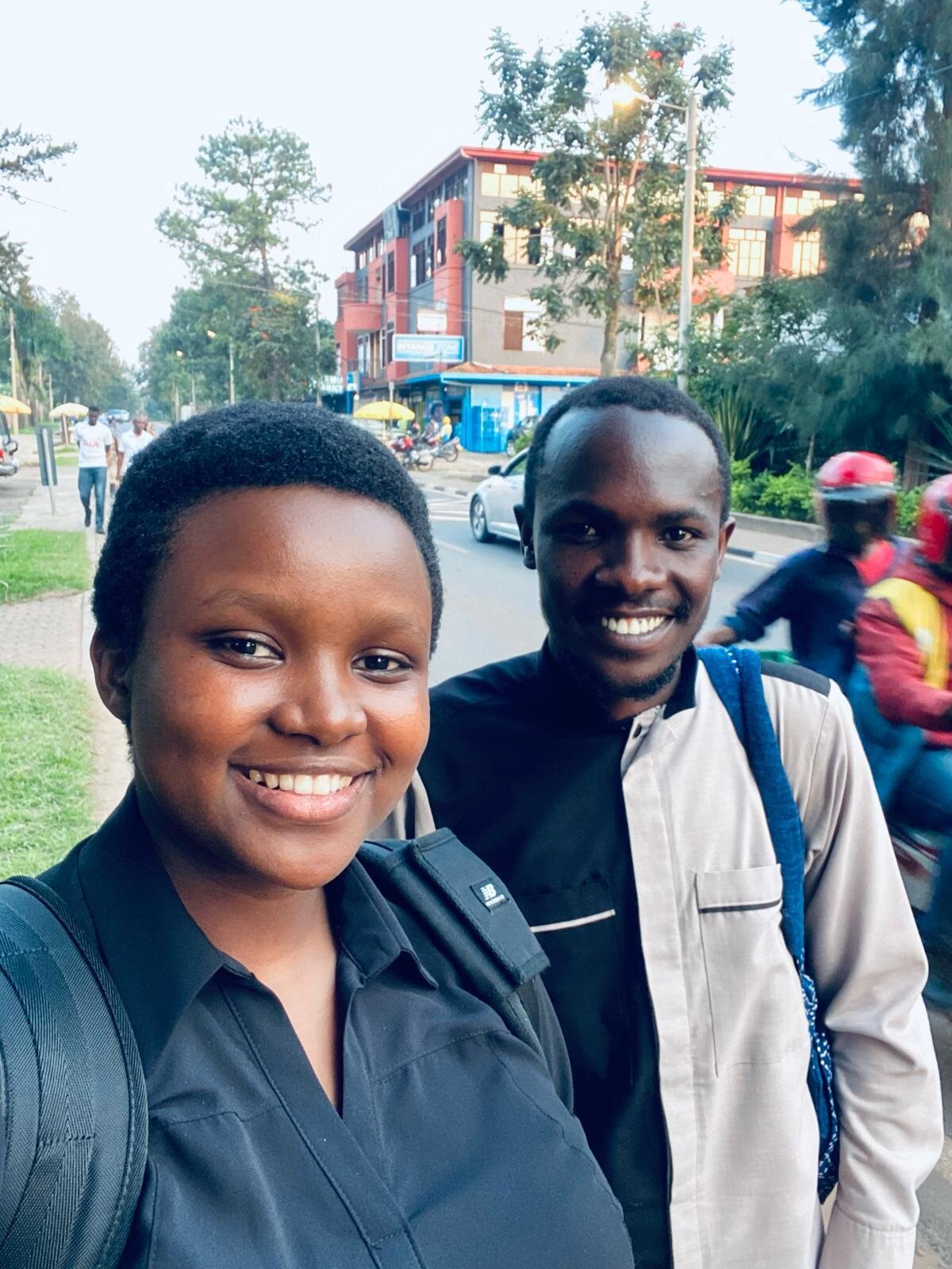 Louise and Aimable smiling on a Kigali street